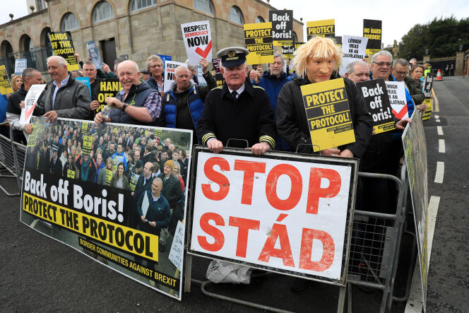 Demonstrators protest outside Hillsborough Castle, ahead of a visit by British Prime Minister Boris Johnson, in Hillsborough, Northern Ireland, Monday, May, 16, 2022. 
