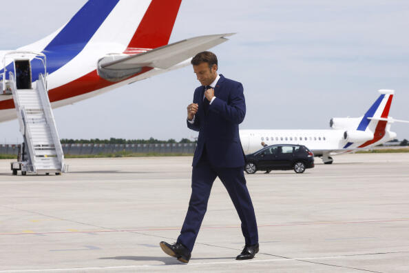 French President Emmanuel Macron arrives to deliver a statement on the tarmac in front of his presidential plane before his departure to visit French NATO troops stationed in Romania, at Paris-Orly airport in Orly, Tuesday, June 14, 2022. Emmanuel Macron urged the French to give him a « strong majority » Sunday in the second, decisive round of nationwide parliamentary elections. (Gonzalo Fuentes/Pool via AP)