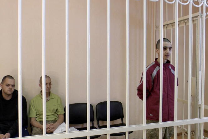 Britons Aiden Aslin and Shaun Pinner and Moroccan Brahim Saadoun, captured by Russian forces during the war in Ukraine and sentenced to death, are here in a courtroom in the self-proclaimed republic of Donetsk, which provided this image on June 8, 2022.