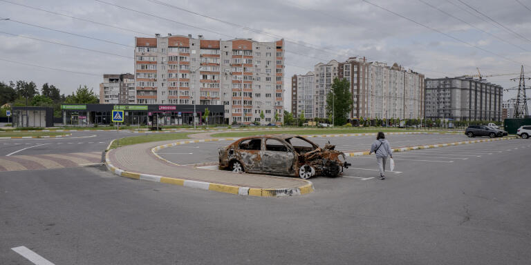 A carcass of a car in Bucha, Ukraine, May 23, 2022. Reconstruction work began in the first days of the Russian army's withdrawal.