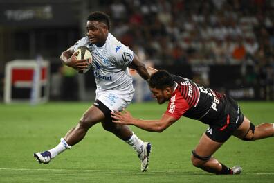 Castres' Fijian wing Filipo Nakosi (L) runs to evade Toulouse's French number 8 Selevasio Tolofua during the French Top 14 semi-final rugby union match between Castres Olympique and Stade Toulousain at the Allianz Riviera Stadium in Nice, southeastern France, on June 17, 2022. (Photo by CHRISTOPHE SIMON / AFP)