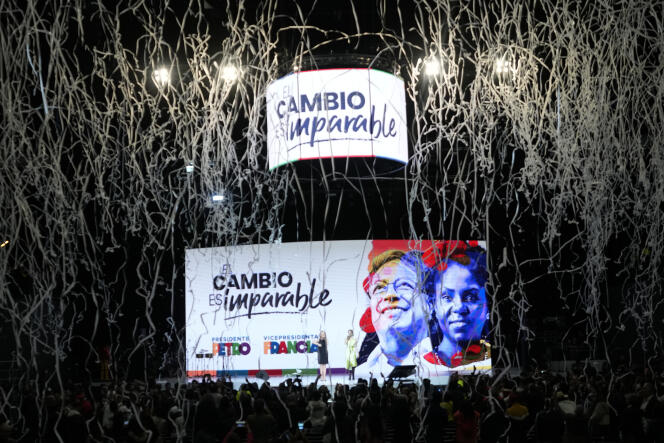 Confetti explodes as the victory of candidate Gustavo Petro (left) in the presidential election is displayed, in Bogota, June 19, 2022. 