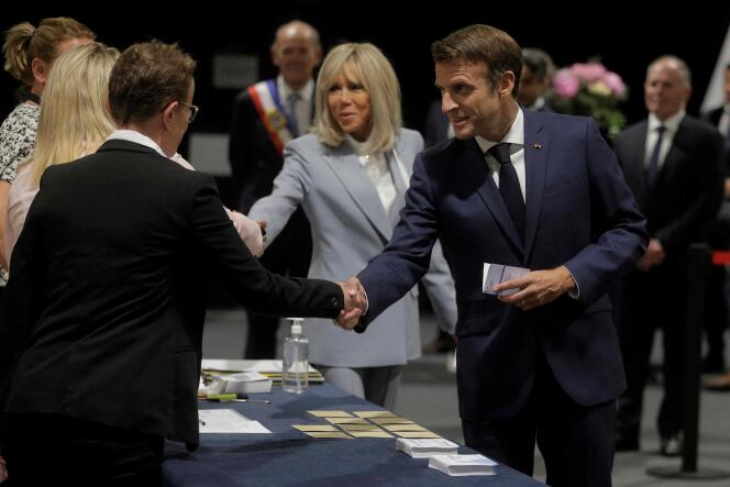 French President Emmanuel Macron and his wife Brigitte Macron arrive to vote in the second stage of French parliamentary elections at a polling station in Le Touquet.