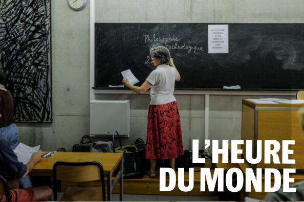 A teacher writes on the board ahead of the start of the philosophy test as part of the baccalaureat exams at the Sainte-Marie Les Maristes high school designed and built by famous architect Georges Adilon, in Lyon, central-eastern France, on June 15, 2022.