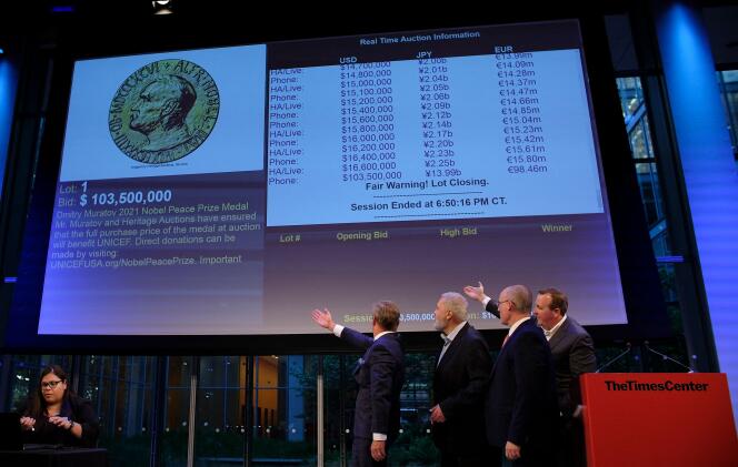 Russian journalist Dmitry Muratov (2L) reacts on stage to the bid of $103.5 million to buy his 2021 Nobel Peace Prize medal in New York, on June 20, 2022.  Dmitry Muratov, the Russian editor-in-chief of the independent newspaper Novaya Gazeta, on Monday auctioned off his Nobel Peace Prize gold medal for a whopping $103.5 million to benefit children displaced by the war in Ukraine.
The medal was sold to an as yet unidentified phone bidder at the sale in New York organized by Heritage Auctions.
 (Photo by Kena Betancur / AFP)