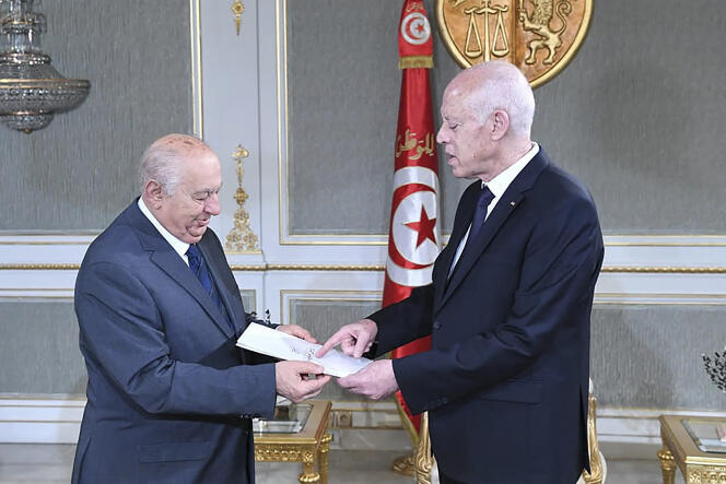 Constitutionalist Sadok Belaid delivers his draft of the new Constitution to Tunisian President Kais Saied at the Carthage Palace in Tunis on June 20, 2022.