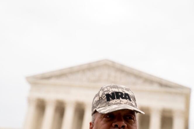 A person wears an NRA hat in front of the US Supreme Court in Washington, DC, on June 21, 2022.