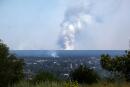 A picture taken on June 21, 2022 from the town of Lysychansk, shows a large plume of smoke rising on the horizon, behind the town of Severodonetsk, amid the Russian invasion of Ukraine. Regional governor Sergiy Gaiday says that non-stop shelling of Lysychansk on June 20 destroyed 10 residential blocks and a police station, killing at least one person. (Photo by Anatolii Stepanov / AFP)