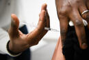 A man receives a dose of a vaccine against the coronavirus disease Covid-19 in a social center of La Gavotte Peyret popular neighbourhood, in Septeme-Les-Vallons, near Marseille, on January 12, 2022. (Photo by CLEMENT MAHOUDEAU / AFP)