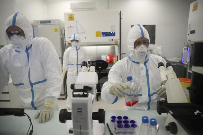 Laboratory technicians work at Valneva's premises in Saint-Herblain, near Nantes, on February 3, 2021.