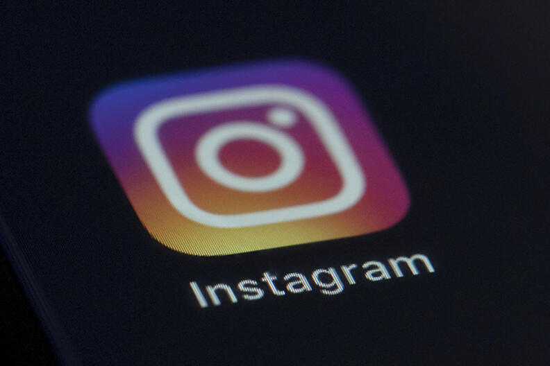 FILE - This Friday, Aug. 23, 2019, file photo shows the Instagram app icon on the screen of a mobile device in New York. Instagram is testing new ways to verify people's age to use the service, including a face-scanning artificial intelligence tool, having mutual friends verify their age or uploading an ID. But the tools won't be used, at least not yet, to try to keep children off of the popular photo and video-sharing app. Rather, they are only for verifying that someone is 18 or older. (AP Photo/Jenny Kane, File)