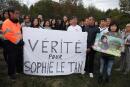 (FILES) This file photograph taken on September 7, 2019, shows the mother (2ndL) and father (C) of Sophie Le Tan stand behind a banner which translates into "The truth for Sophie Le Tan" during a march to pay tribute to the disappeared student, in Mundolsheim, eastern France on September 7, 2019. Jean-Marc Reiser, a 58-year-old man, is set to appear in front of jurors of the Bas-Rhin Department on June 27, 2022, for the murder of 20-year-old student Sophie Le Tan. (Photo by FREDERICK FLORIN / AFP)