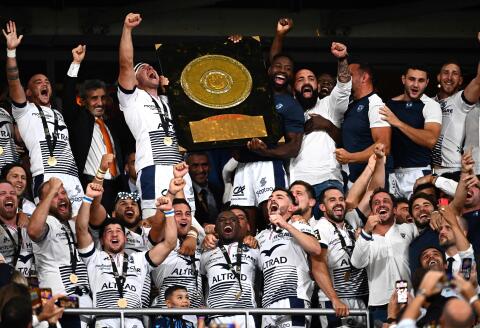 Montpellier's French-Syrian President Mohed Altrad (2L), Montpellier's French hooker Guilhem Guirado (3L), Montpellier's French flanker Fulgence Ouedraogo (5R) and their teammates celebrate with the Bouclier de Brennus trophy after winning the French Top 14 final rugby union final between Castres Olympique and Montpellier Herault Club at Stade de France stadium in Saint-Denis, north of Paris, on June 24, 2022. (Photo by Anne-Christine POUJOULAT / AFP)