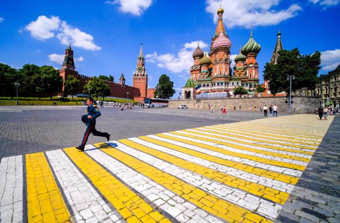 A Russian officer crosses the square in front of Saint Basil's Cathedral near the Kremlin in Moscow on June 25, 2022.