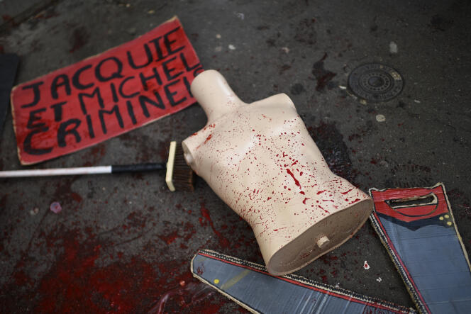 A bloody mannequin lies on the ground in front of the Jacquie et Michel sex shop after a protest by the feminist collective Les Amazones to condemn the exploitation of women in the porn industry, in Paris, February 19, 2022.