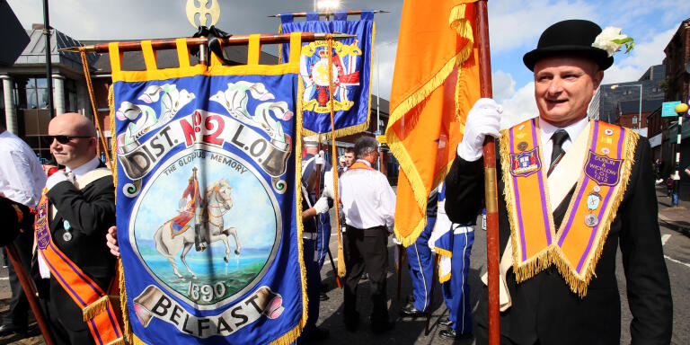Orangemen take part in the annual July 12 parade in Belfast, on July 12, 2017. - July 12 is the main marching day in the Orange Order calendar. The parades mark the Protestant commemoration of the 327th anniversary of King William III's victory at the Battle of the Boyne in 1690. (Photo by Paul FAITH / AFP)