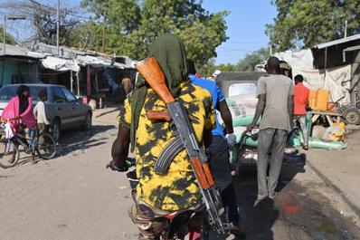 A Nigerian soldier cycles at a market near the Diffa airport in southeastern Niger, near the Nigerian border, on December 23, 2020. 