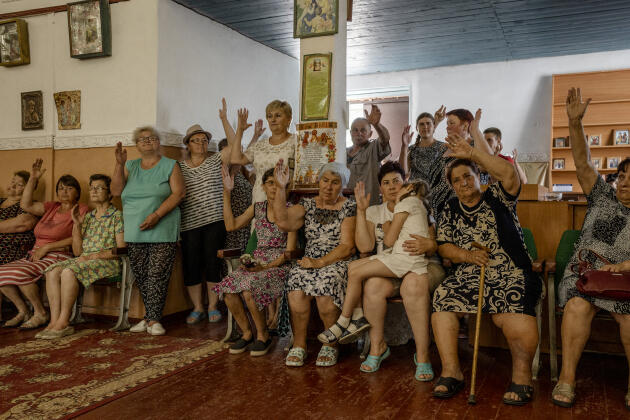 Villagers vote by a show of hands to change the priest and clergy in the church of the Holy Apostles Peter and Paul in Zelene Pole, Ukraine, on June 19, 2022.