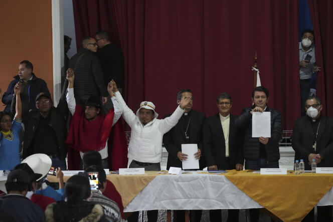 Francisco Jimenez, government representative, shows the agreement signed with indigenous leaders Eustaquio Toala and Leonidas Iza, June 30, 2022.