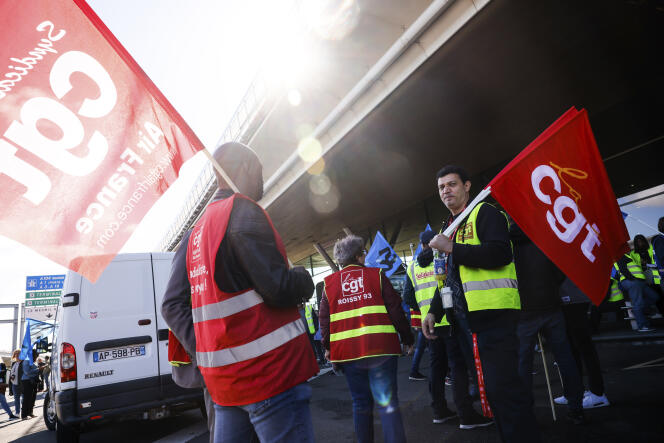 Unionists strikers from the General Work Confederation (CGT) gather outside a terminal Friday, July 1, 2022 at Roissy-Charles de Gaulle airport, north of Paris.