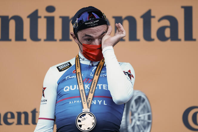 Stage winner and new overall leader Belgium's Yves Lampaert wipes a tear on the podium after the first stage of the Tour de France cycling race, an individual time trial over 13.2 kilometers with start and finish in Copenhagen, Denmark, Friday, July 1, 2022.