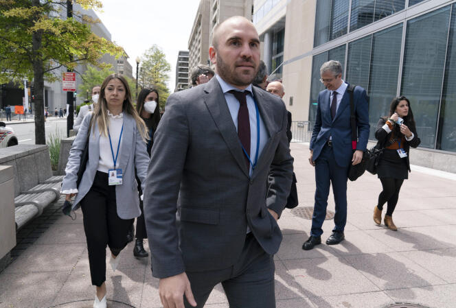 Argentina's Economy Minister Martin Guzman walks outside of the International Monetary Fund, IMF, building during the IMF Spring Meetings, in Washington, April 21, 2022.