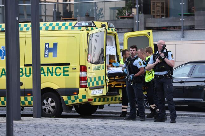 Des policiers escortent des secouristes vers une ambulance, à Copenhague, dimanche 3 juillet 2022.
