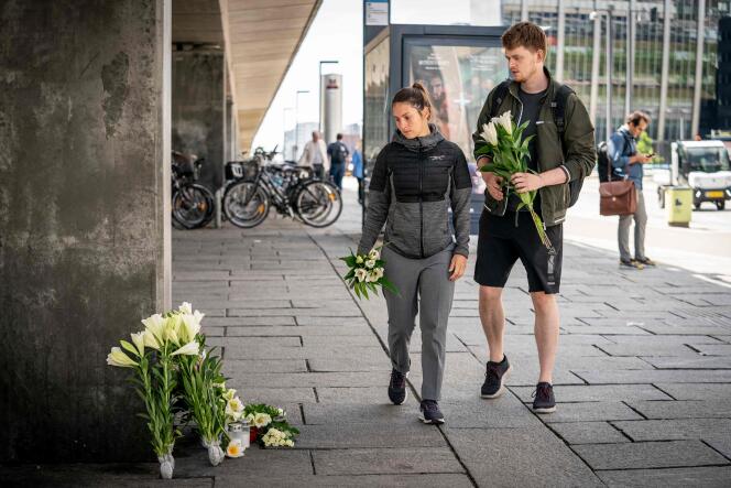 People arrive to place flowers at a makeshift memorial installed at the site of a shooting at Fields mall, the day after the deadly shootings, in Copenhagen, Denmark, on July 4, 2022. 