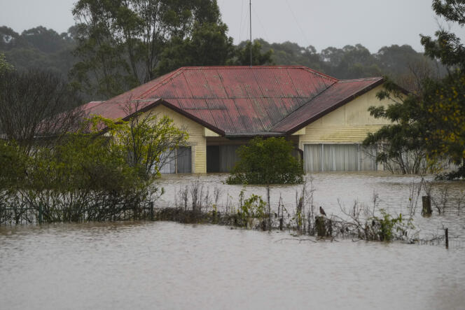 A house has been flooded in Windsor, a suburb of Sydney, Australia.  The country is particularly affected by climate change.