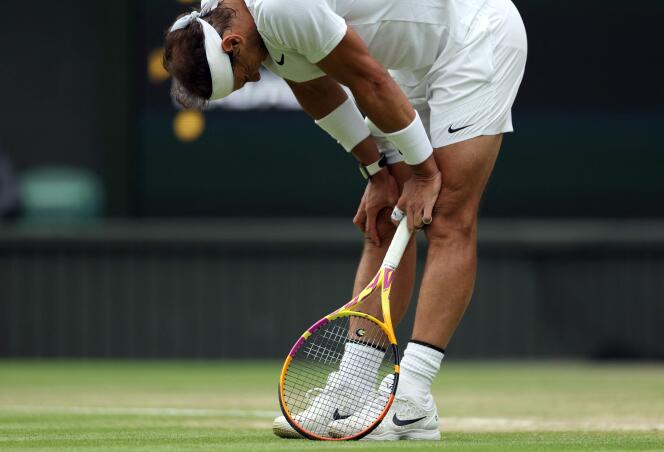 Spain's Rafael Nadal reacts bending over prior to receiving medical assistance on the tenth day of the 2022 Wimbledon Championships at The All England Tennis Club in Wimbledon, southwest London, on July 6, 2022. 