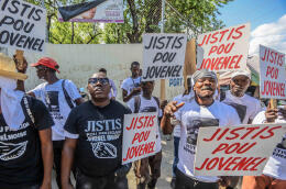 A group of activists demands justice for former Haitian President Jovenel Moise, as Martine Moïse is interviewed as a witness by the judge who is investigating his assassination in Port-au-Prince on October 6, 2021. (Photo by Richard PIERRIN / AFP)