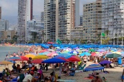 In this file photo taken on June 7, 2022 people sunbathe and enjoy a sunny day on Levante Beach in Benidorm. 