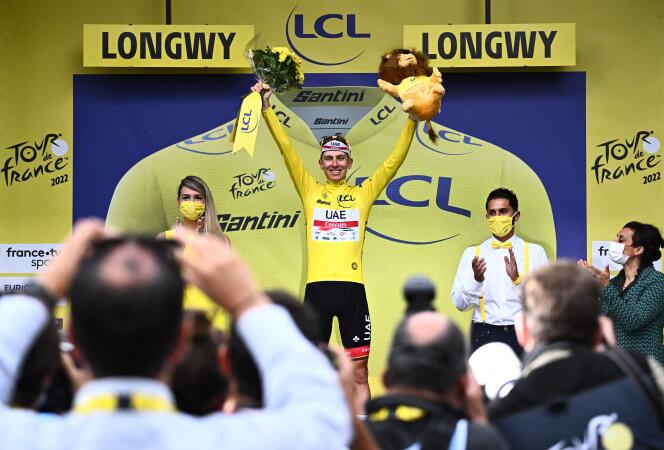 UAE Team Emirates team's Slovenian rider Tadej Pogacar wearing the overall leader's yellow jersey celebrates on the podium after the 6th stage of the 109th edition of the Tour de France in Longwy, northern France, on July 7, 2022.