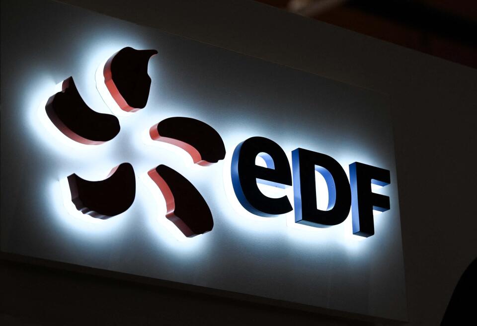 The logo of French electricity giant EDF is pictured at the International Cybersecurity Forum (FIC) in Lille, northern France, on June 8, 2022. (Photo by DENIS CHARLET / AFP)