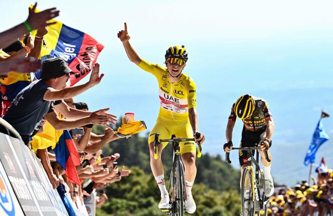 UAE Team Emirates team's Slovenian rider Tadej Pogacar wearing the overall leader's yellow jersey celebrates as he cycles past Jumbo-Visma team's Danish rider Jonas Vingegaard to win the 7th stage of the Tour de France.