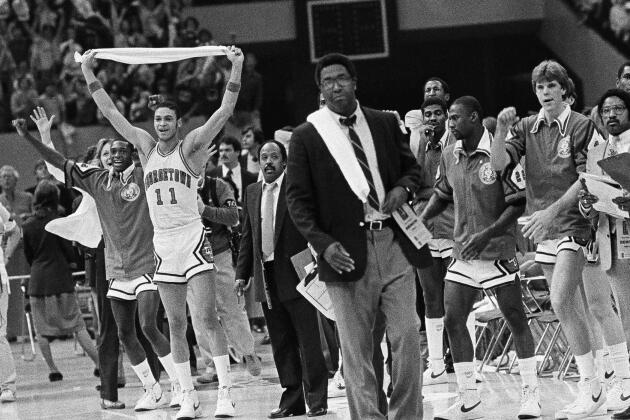 Members of the Georgetown team wave their arms in victory after defeating Louisville on March 27, 1982, in the semifinals of the NCAA men's college basketball tournament in New Orleans, Louisiana.