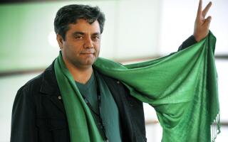 (FILES) In this file photo taken on September 19, 2009, Iranian director Mohammad Rasoulof shows his green scarf during a photocall after the screening of his film "The White Meadows", during the second day of the 57th San Sebastian International Film Festival in San Sebastian. The Islamic republic's state news agency IRNA reported on July 9, 2022 that Mohammad Rasoulof, an Iranian award winning film-maker, had been arrested along with colleague Mostafa Aleahmad. On July 11, another award-winning dissident Iranian film-maker, Jafar Panahi, was also reported detained, to become the third director to be arrested in less than a week, according to Iran's Mehr news agency. (Photo by Rafa RIVAS / AFP)