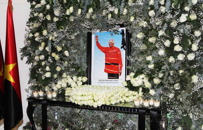 A photo of former Angolan President Jose Eduardo dos Santos, surrounded by flowers, shortly after his death in Barcelona at the age of 79, on July 11, 2022, in Luanda, Angola.