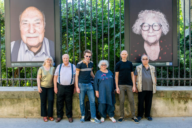 Marcel and Ida Apeloig and other members of their family in front of Luigi Toscano's photographs for the CRIF displayed on the gates of the Jardin du Luxembourg in Paris on July 11.