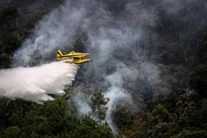 A firefighter aircraft Air Tractor AT-802F Fire Boss drops water in a wildfire near Bustelo, east of Amarante, north of Portugal, on July 16, 2022. 