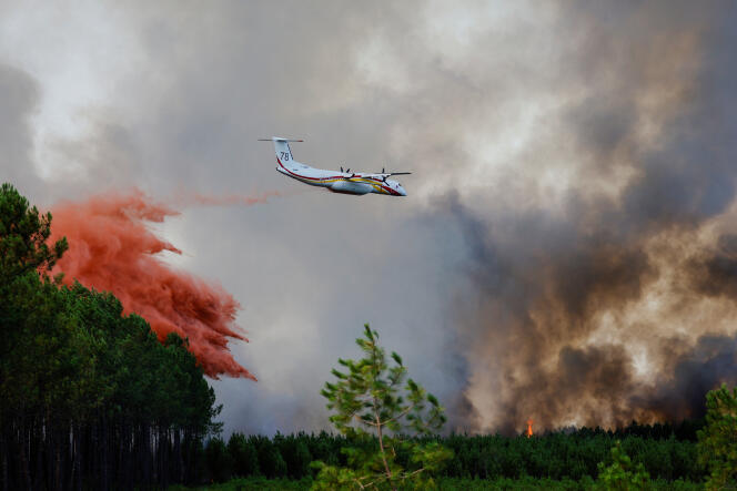 A firefighting plane drops flame retardant to extinguish a fire in Guillos, as wildfires continue to spread in the Gironde region of southwestern France, July 16, 2022. 