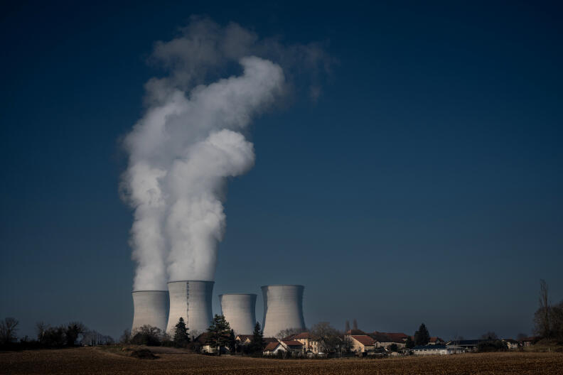 A photograph shows smoke rising from chimneys of the Bugey nuclear power plant on January 25, 2022, in Saint-Vulbas, central eastern France. - Operating since 1972, the Bugey power plant, located in Saint-Vulbas in the Ain region, plays an active role in the development of the region's economic fabric. (Photo by JEAN-PHILIPPE KSIAZEK / AFP)