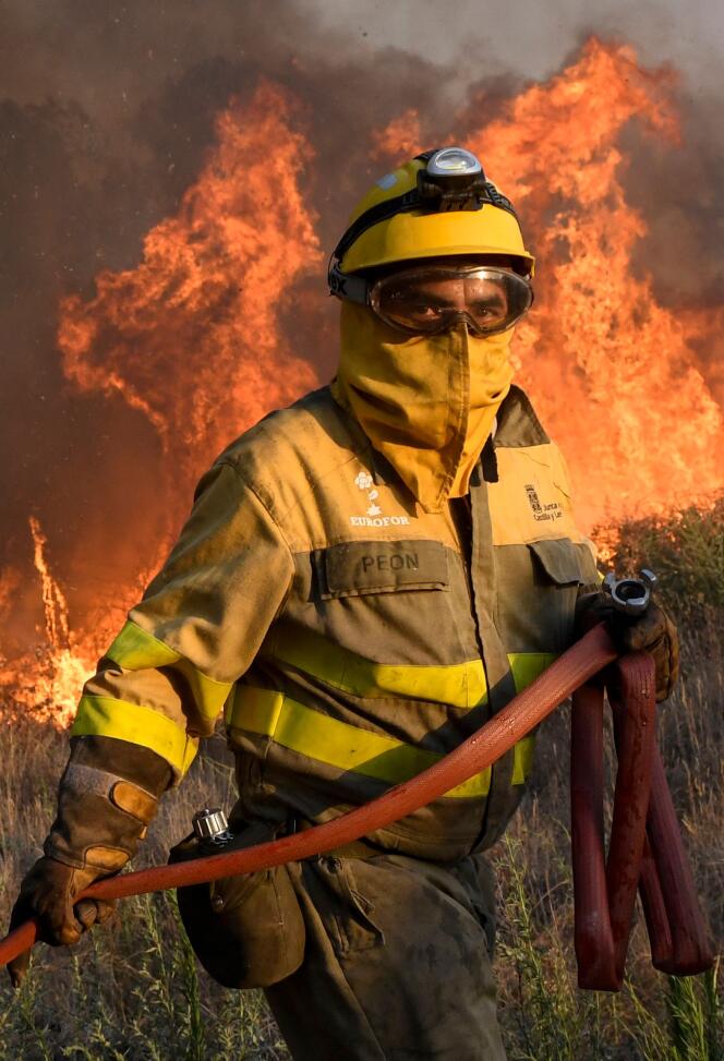 A Spanish firefighter tries to control a fire near the village of Tabara near Zamora, north of the country, on July 18, 2022.