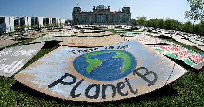 Activists place thousands of protest placards in front of the Reichstag building, home of the german federal parliament, Bundestag, during a protest rally of the 'Fridays for Future' movement in Berlin, Germany, Friday, April 24, 2020.