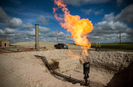 WILLISTON, ND - JULY 26: A gas flare is seen at an oil well site on July 26, 2013 outside Williston, North Dakota. Gas flares are created when excess flammable gases are released by pressure release valves during the drilling for oil and natural gas. North Dakota has been experiencing an oil boom recently, bringing tens of thousands of jobs to the region, lowering state unemployment and bringing a surplus to the state budget. Andrew Burton/Getty Images/AFP (Photo by Andrew Burton / GETTY IMAGES NORTH AMERICA / Getty Images via AFP)