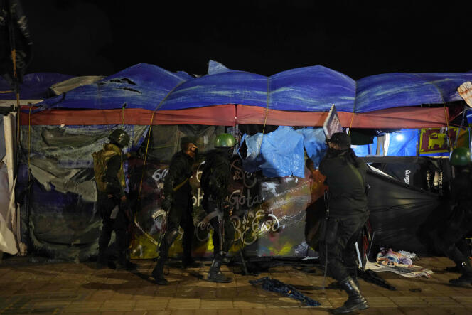 Security forces remove tents from the site of a protest camp outside the presidential secretariat in Colombo, Sri Lanka, Friday, July 22, 2022.