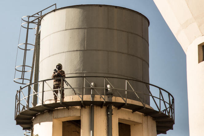 A Malian soldier stands guard from a water tower during a ceremony in Kati, Mali, January 20, 2022.