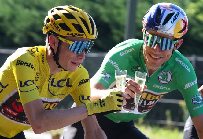 Yellow jersey Jonas Vingegaard and green jersey Wout van Aert sip on some champagne on the way to Paris, during the final stage of the Tour de France.