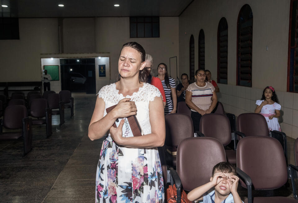 APUI, BRAZIL - MAY 29, 2022: Evangelical Christians worship inside the church Assembleia de Deus in Apui, Amazonas state. While Brazil remains the world’s most populous Catholic nation, it has a significant and fast growing community of Evangelical Christians that today account for about a quarter of the population. In Brazil’s Amazon states, Evangelical mega churches with huge congregations are present in urban centres while tiny churches little more than wooden shacks proliferate in isolated river towns only accessible by long boat journeys.
