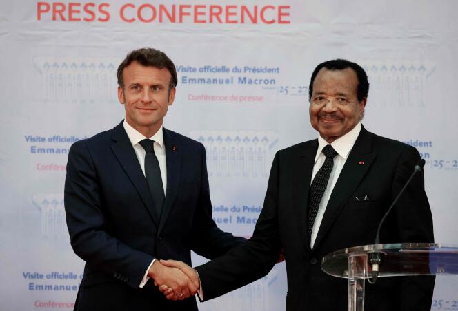 France's President Emmanuel Macron and Cameroon's President Paul Biya shake hands during a press conference in Yaounde, on July 26, 2022.